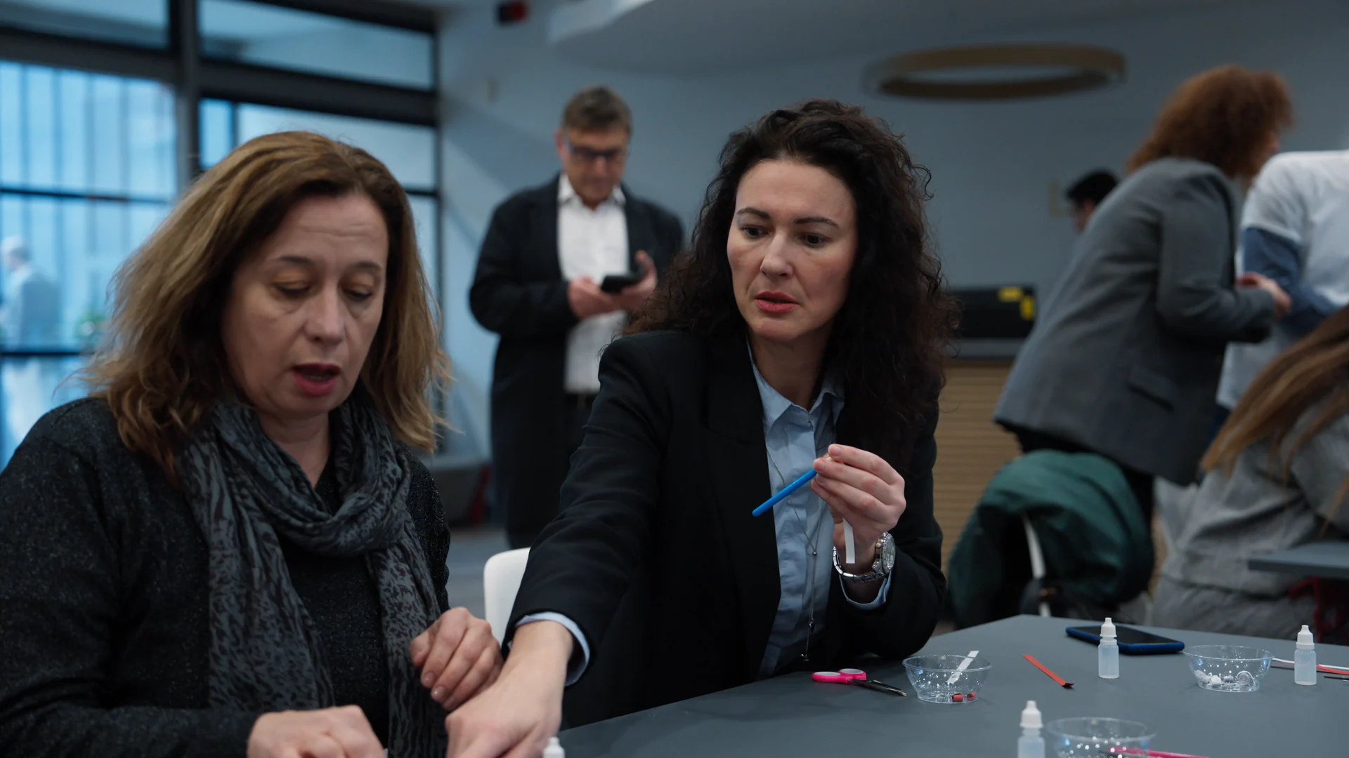 Two participants working together at a workshop table