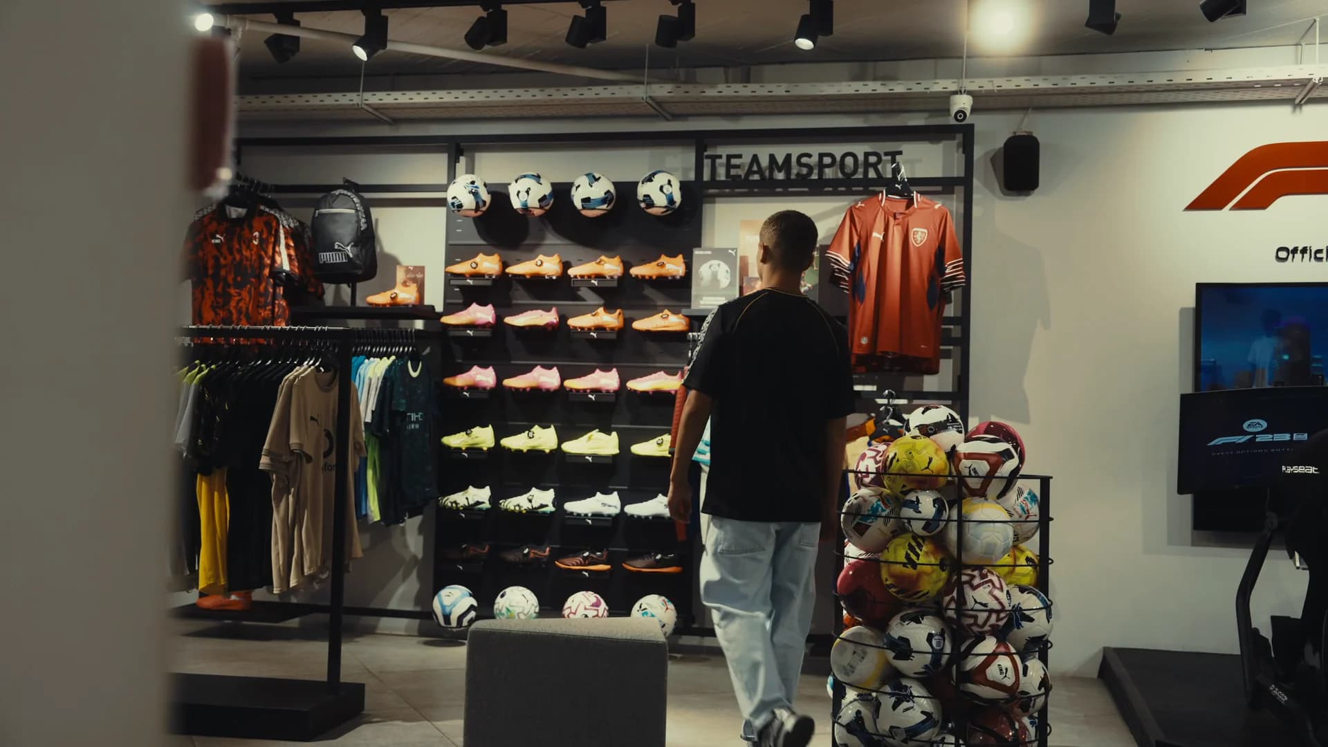 Mouzakitis studying a wall of football boots inside the store