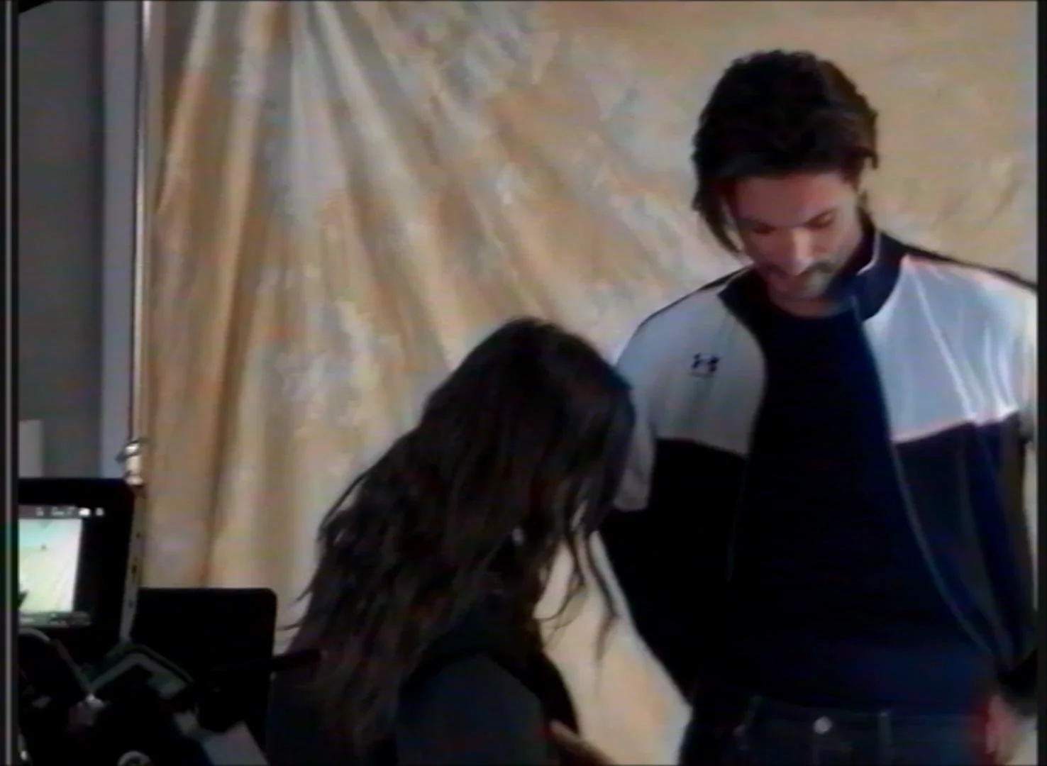 Black-and-white behind-the-scenes view of a wardrobe fitting with Karavas